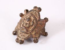 AN EARLY INDIAN BRONZE AMULET, possibly 12th Century, cast with a seated Buddha, 7cm wide.