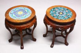 A PAIR OF CHINESE CLOISONNE CARVED HARDWOOD CIRCULAR TABLES, each table with carved bat frieze and