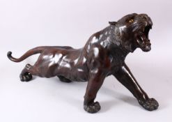 A LARGE JAPANESE MEIJI PERIOD BRONZE TIGER - SIGNED, the siger in a striding pose with patinated