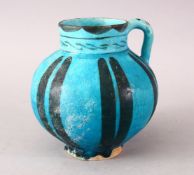 A GOOD EARLY ISLAMIC RAQQA POTTERY EWER, with a blue glaze and decorated striping, 16cm.