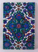 A VERY LARGE UNUSUAL POTTERY PORCELAIN IZNIK TILE, decorated with typical floral motif decoration