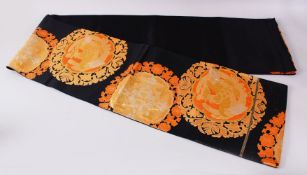 A FINE QUALITY JAPANESE EMBROIDERED SILK FUKURO OBI TIE, with a black ground and floral, phoenix