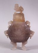 A CHINESE CARVED AGATE VASE AND COVER, with four carved lion dog head handles and rings, stood