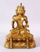 A CHINESE GILT BRONOZE IGURE OF BUDDHA / DEITY, in a seated position holding implements, 18.5cm