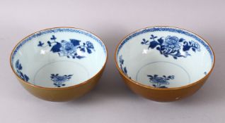 A PAIR OF CHINESE NANING CARGO BLUE & WHITE BOWLS, with a cafe au lait exterior glaze and floral