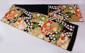 A FINE QUALITY JAPANESE EMBROIDERED SILK FUKURO OBI TIE, with a black ground and floral and gilt