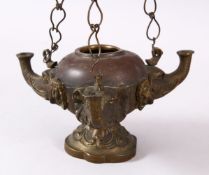 AN INDIAN ELEPHANT FORMED BRONZE HANGING OIL LAMP, with three elephant heads and chains, 16cm wide.