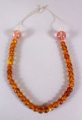 A GOOD CHINESE OR TIBET CARVED AMBER & AMETHYST NECKLACE, with 35 amber beads and two larger