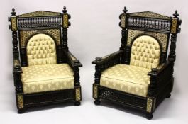 A LARGE PAIR OF LATE 19TH CENTURY MOORISH EBONISED ARMCHAIRS with upholster backs and loose
