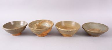 FOUR EARLY CHINESE GREEN GLAZED POTTERY BOWLS, 15m down to 14cm