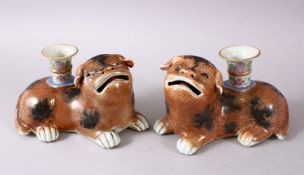 A PAIR OF CHINESE 18TH / 19TH CENTURY FAMILLE ROSE DOG FORMED CANDLESTICKS, with canton decorated
