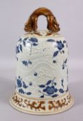 A CHINESE BLUE, WHITE & BISCUIT MING STYLE DRAGON PORCELAIN TEMPLE BELL, the body with moulded