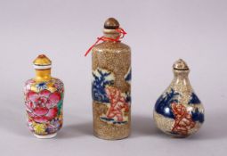 THREE CHINESE PORCELAIN SNUFF BOTTLES, one of floral design, the other two with underglaze blue