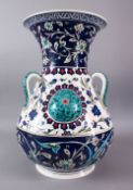 A LARGE TURKISH OTTOMAN STYLE CERAMIC FLORAL LAMP VASE, with three moulded handles and three bosses,