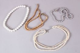 A MIXED LOT OF FOUR CARVED PEARL NECKLACES, (4)