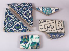 A GROUP OF FIVE 16TH/17TH CENTURY IZNIK AND DAMASCUS TILE FRAGMENTS.