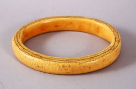 A LARGE 19TH CENTURY OR EARLIER CARVED IVORY BANGLE, 13cm external