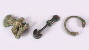 AN EARLY PERSIAN BRONZE ZOOMORPHIC AXE HEAD, together with bangle and dagger handle, axe 12cm high.