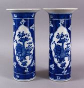 A PAIR OF CHINESE BLUE & WHITE PORCELAIN SLEEVE VASES, each decorated with panels of floral display,