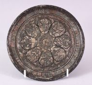 A 19TH CENTURY BIDRI CIRCULAR DISH, inlaid a radiating foliate design, 17cm diameter.