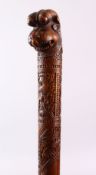 A GOOD LATE 19TH CENTURY INDIAN CARVED WOOD WALKING STICK, the handle modelled as a mythological