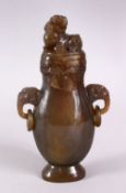 A CHINESE CARVED JADE / JADE LIKE TWIN HANDLE VASE & COVER, with twin carved lion handles and rings,