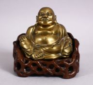 A 19TH CENTURY CHINESE BRONZE FIGURE OF BUDDHA & STAND, seated with his hand upon his knee, in a