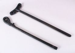 TWO ISLAMIC TURKISH SUFI STICKS, each with carved handles, one handle with a green glaze like