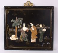 A CHINESE CARVED HARD STONE INLAID PANEL, depicting figures in a garden setting upon a lacquer