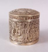 AN INDIAN CALCUTTA WHITE METAL CIRCULAR LIDDED BOX & COVER, possibly silver, with moulded decoration