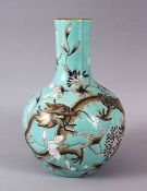 A CHINESE TURQUOISE GROUND DRAGON VASE, decorated upon a turquoise glaze with enameled dragons and