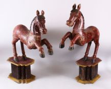 A LARGE PAIR OF CHINESE TANG STYLE CARVED WOODEN HORSE FIGURES, both slotted upon separate