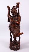 A LARGE 19TH CENTURY CHINESE CARVED HARDWOOD FIGURE OF A DEVIL, stood upon a wave formed base with