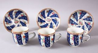 A SET OF 3 19TH CENTURY CHINESE FAMILLE ROSE CUP & SAUCERS, with bands of floral decoration, cups