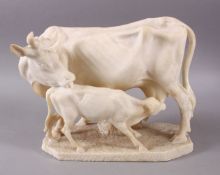 A 19TH CENTURY INDIAN ALABASTER MODEL OF NANDI COWS - the larger cow depicted with young, 25cm
