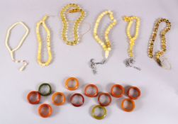 A MIXED LOT OF 6 CARVED AMBER BEAD NECKLACE & 12 BAKELITE NAPKIN RINGS - comprising 6 individual