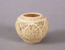 A 19TH CENTURY PERSIAN QAJAR IVORY INKWELL, with panels of carved decoration, 3.5cm high.