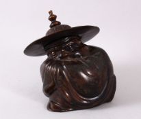A CHINESE BRONZE FIGURE OF A CROUCHING MAN IN A HAT, 14cm high x13cm wide