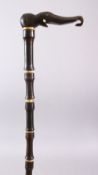 AN 18TH CENTURY MUGHAL RHINO HORN AND BONE WALKING STICK, carved in section with Rhino horn and