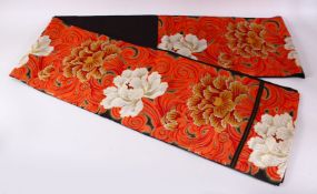 A FINE QUALITY JAPANESE EMBROIDERED SILK FUKURO OBI TIE, with a black and red ground with floral and