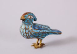 A PERSIAN / ISLAMIC ENAMEL MODEL OF A BIRD, with a turquoise ground, 6cm wide.