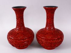 A PAIR OF CHINESE CINNABAR LACQUER BOTTLE VASES, with decoration depicting panels of village