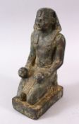 AN EGYPTIAN STONE FIGURE, in a knelt position holding two bowls, 27cm high