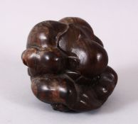 AN ORIENTAL CARVED HARDWOOD FIGURE OF A FIGURE, in a seated downward position with its hands