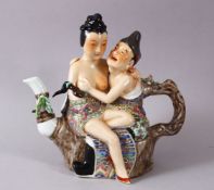 A CHINESE FAMILLE ROSE REPUBLIC STYLE EROTIC PORCELAIN TEAPOT, with two figures seated, 21.5cm