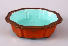 A CHINESE COPPER RED PORCELAIN SHALLOW DISH, with copper red ground and gilt decoration, upon four