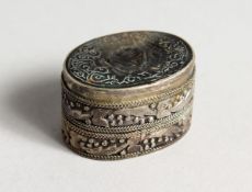 A SMALL OVAL SILVER PILL BOX with seal top. 1.25 ins.