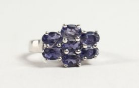 A SILVER SEVEN STONE SAPPHIRE RING