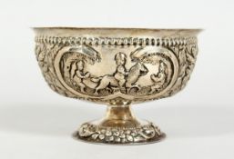 A CONTINENTAL SILVER CIRCULAR PEDESTAL BOWL 5 ins diameter, repousse with cows, horses, figures
