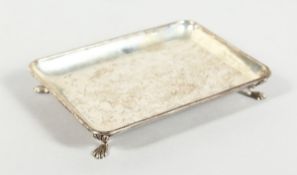 A PLAIN SILVER RECTANGULAR DISH on four claw feet, 4.25 oz, Birmingham 1961